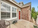 Cozy patio with a red door, brick accent wall, and room for seating at 16366 E Fremont Ave # 11, Aurora, CO 80016