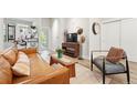 Cozy living room showcasing wood floors, comfortable seating, and seamless flow to the outdoor balcony at 6619 E Lowry Blvd # 101, Denver, CO 80230