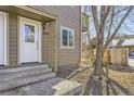 Up close exterior view of a home entry door with a side window, steps and an outdoor light fixture at 4529 Barnacle Ct, Boulder, CO 80301