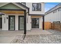 Close-up of a modern home's entrance featuring clean lines, a green door, and crisp details at 2430 Ames St, Edgewater, CO 80214