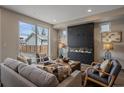 Comfortable living room with modern fireplace and large windows overlooking the backyard at 2430 Ames St, Edgewater, CO 80214