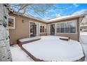 Spacious backyard patio with snow covering, ideal for outdoor relaxation at 810 Meadow Run, Golden, CO 80403