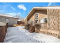 Private backyard with a wooden deck and snow-covered ground at 810 Meadow Run, Golden, CO 80403