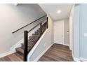 Bright foyer featuring hardwood floors, a modern staircase with metal accents, and access to the main floor at 2648 Mayotte Way, Castle Rock, CO 80109