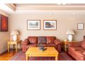 Cozy living room featuring a leather sofa set, decorative art, and stylish lamps at 1900 E Girard Pl # 608, Englewood, CO 80113