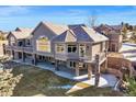 Gorgeous home featuring a stone foundation, light gray siding, and balconies on multiple levels at 4749 Starfire Cir, Castle Rock, CO 80104