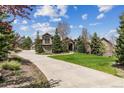 Stately home with lush landscaping, mature trees, and a long private driveway at 4749 Starfire Cir, Castle Rock, CO 80104