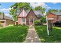 Charming brick Tudor-style home with inviting front yard and manicured lawn at 3055 N Albion St, Denver, CO 80207