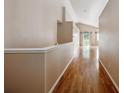 Hallway with hardwood floors, leading to living area at 11418 Macon St, Commerce City, CO 80640