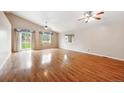 Spacious living room with hardwood floors, vaulted ceilings, and large windows at 11418 Macon St, Commerce City, CO 80640