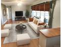 Bright living room with hardwood floors, comfy seating, and a large TV at 3480 W 96Th Ave, Westminster, CO 80031