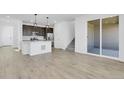 Spacious open-concept living area featuring contemporary finishes and durable plank flooring at 9022 Spaulding St, Parker, CO 80134