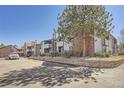 Apartment complex with brick accents, well-maintained landscaping, and ample parking at 11937 E Harvard Ave # 102, Aurora, CO 80014