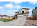 Attractive home exterior featuring a stone-accented garage and nicely maintained landscaping at 14836 Jersey Dr, Mead, CO 80542