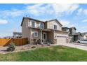 Two-story home with an attached garage and well-manicured front lawn and a classic fence at 14836 Jersey Dr, Mead, CO 80542