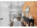 Inviting foyer featuring wood floors, stylish decor, and an open view to the living area at 14836 Jersey Dr, Mead, CO 80542