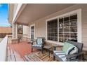 Inviting front porch with comfortable seating, offering a relaxing outdoor space with ample light at 4023 E Geddes Cir, Centennial, CO 80122