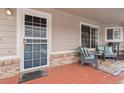 Charming front porch with seating, a decorative rug, and a window reflecting natural light at 4023 E Geddes Cir, Centennial, CO 80122