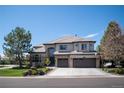 Stunning two-story home featuring stone accents, a three-car garage, and beautifully landscaped front yard at 9445 Aspen Hill Cir, Lone Tree, CO 80124