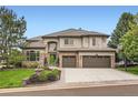 Beautiful two-story home with stone accents, mature trees, and a well-manicured lawn at 9445 Aspen Hill Cir, Lone Tree, CO 80124