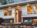 Close up of front door, showing modern design, brick accent, and landscaped garden at 11900 W 18Th Ave, Lakewood, CO 80215