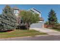Charming two-story home with a well-maintained front yard and a gray two-car garage at 1909 Alpine Dr, Erie, CO 80516