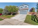 Charming two-story home with a well-maintained front yard and a gray two-car garage at 1909 Alpine Dr, Erie, CO 80516