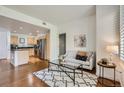 Open concept living room with modern furniture and kitchen view at 3601 Arapahoe Ave # 102, Boulder, CO 80303