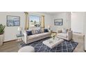 Cozy living room with stylish furniture, plush carpet, and a bright window at 1720 Pecos Way, Denver, CO 80221