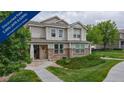 Charming two-story home with manicured lawn, stone accents and a welcoming front porch at 9758 Laredo St # 22D, Commerce City, CO 80022