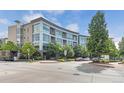 Modern condo building featuring a contemporary design and manicured landscaping at 2958 Syracuse St # 403, Denver, CO 80238