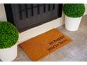 Stylish front door with 'so happy you're here' doormat and decorative potted plants at 2676 S Lincoln St, Denver, CO 80210