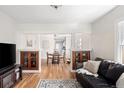 Inviting living room with hardwood floors, wood trim details, and an open view to the dining area at 2676 S Lincoln St, Denver, CO 80210