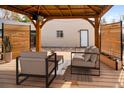 Relax on the covered patio with outdoor seating, privacy screens, and string lights at 2676 S Lincoln St, Denver, CO 80210