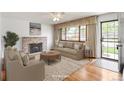 Inviting living room with a cozy fireplace, a large window, and stylish furnishings at 1840 E 84Th Ave, Denver, CO 80229
