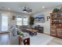 Comfortable living room with a large gray sofa, stylish coffee table, ceiling fan, and decor at 527 Felicity Loop, Castle Rock, CO 80109