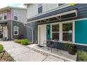 Charming townhouse featuring a covered entry, chairs, and well maintained landscaping at 2829 W 53Rd Ave # 104, Denver, CO 80221