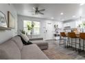 Bright living room flowing into a modern kitchen with breakfast bar seating at 2829 W 53Rd Ave # 104, Denver, CO 80221