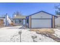 Brick ranch home with attached garage, and snow-covered front yard at 16851 E Mansfield Cir, Aurora, CO 80013