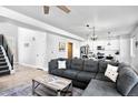 Spacious living room with a large gray sectional, modern decor, and open access to the kitchen at 5347 Osceola St, Denver, CO 80212