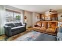 Sunlit living room featuring hardwood floors, a large window, and comfortable seating at 1492 S Cathay St, Aurora, CO 80017