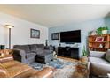 Inviting living room with blue accent wall, comfortable seating, and natural light at 1492 S Cathay St, Aurora, CO 80017