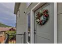Charming home exterior featuring a welcoming front door with a decorative floral wreath at 265 Upper Glenway, Palmer Lake, CO 80133