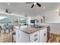 Kitchen island boasts granite countertop, bar seating, and scenic mountain views at 265 Upper Glenway, Palmer Lake, CO 80133