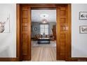 View of a cozy living room through wooden pocket doors, showcasing a comfortable seating area at 1554 N Pennsylvania St, Denver, CO 80203
