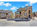 Exterior of a townhome showcasing the facade with garages, second-floor balcony, and well-maintained landscaping at 10546 Graymont Ln # D, Highlands Ranch, CO 80126