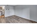 A bright bedroom featuring wood floors, a neutral wall color, and access to an ensuite bathroom at 2929 W Floyd Ave # 217, Denver, CO 80236