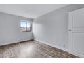 Bedroom with wood floors, a window, and a closet door, creating a bright and inviting space at 2929 W Floyd Ave # 217, Denver, CO 80236