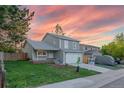 Two-story home with an attached garage, a landscaped yard and a charming brick garden at 4249 S Biscay Cir, Aurora, CO 80013