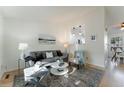 Bright living room with modern decor, natural light, and open view to the kitchen at 4249 S Biscay Cir, Aurora, CO 80013
